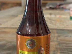 Panchan Amrit Syrup bottle with label on wooden surface.